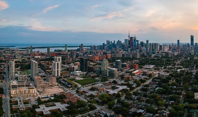 Fototapeta premium Aerial panoramic view of Toronto city skyline with streets, roads, infrastructure, residential areas and parks at dusk. Shot with drone. 