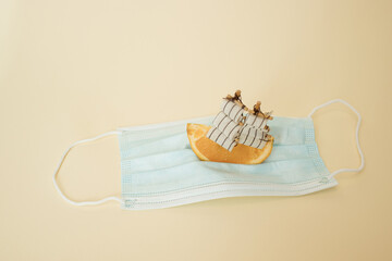 Vacations in pandemic.Sailling on covid 19 mask.Minimal concept.