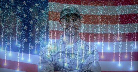 Composition of smiling american soldier with glowing fireworks over american flag