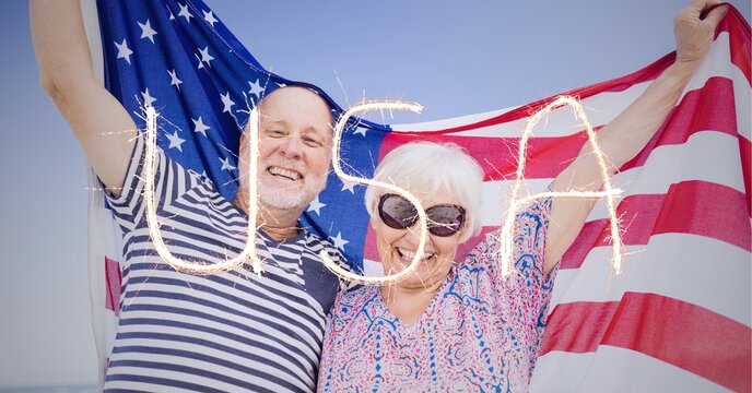 Composition of sparkling usa text over senior couple holding american flag