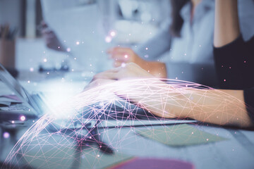 Double exposure of woman hands typing on computer and social network theme hologram drawing. People...