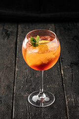 Side view on a glass of fresh aperole spritz cocktail