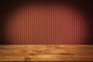 The background is blank wooden boards and a textured striped wall with gradient lighting and vignetting.