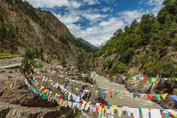 Lungta buddhist prayer flags in Lahaul valley over Chandra river