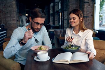 business man and woman breakfast in a cafe communication work colleagues
