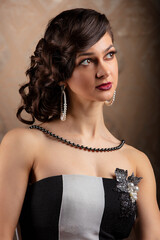 Retro woman portrait. Beautiful lady in 20s or 30s style. Old fashionable Finger Wave makeup and...