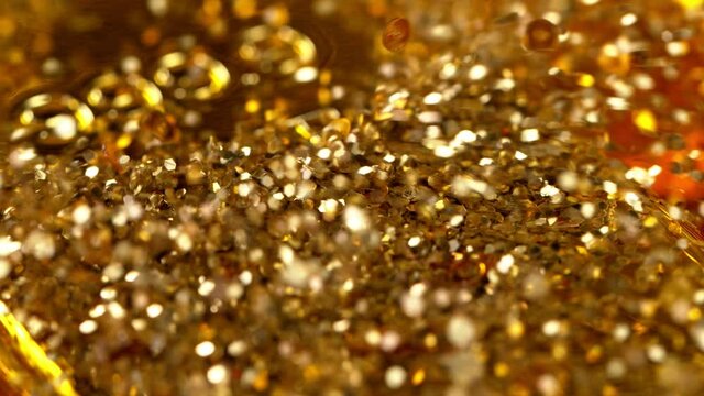 Close-up view of shiny gold bars stacked up with ambient light reflected from its surfaces.