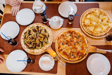 Delicious pizza close-up in a cafe during a friendly dinner.