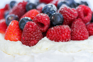 Pavlova cake with meringue, cream and red berries