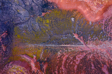Aerial drone view of industrial chemicals dump site, dry multicolored soil, unique texture.