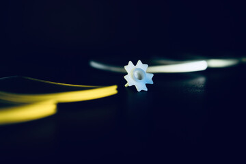 white plastic object on dark background