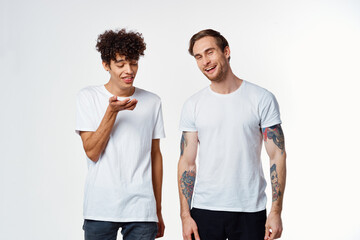 two friends in white t-shirts communication fun positive