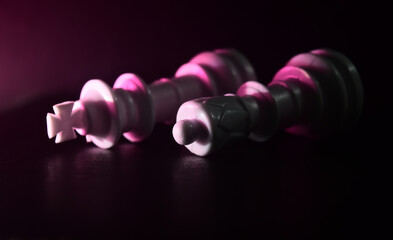 plastic chess characters on dark surface