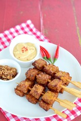 Tempeh Skewers served with spicy peanut sauce and fried onion