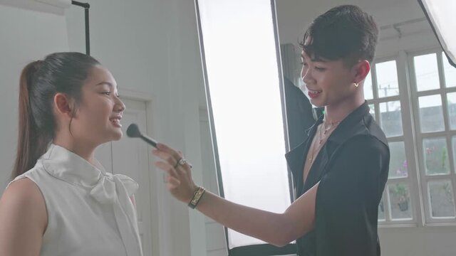 Backstage Of The Photo Shoot: Make-Up Artist Applies Makeup On Beautiful Asian Model
