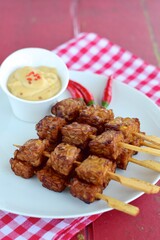 Tempeh Skewers served with spicy peanut sauce and fried onion