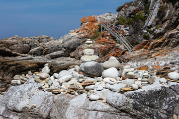 rocky beach with a pile of stones and wooden stairs