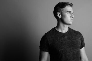 Closeup profile view of young handsome man in black and white