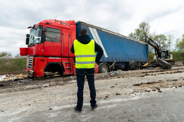Highway road freight lorry accident. Crashed broken cargo semi trailer truck on freeway roadside...