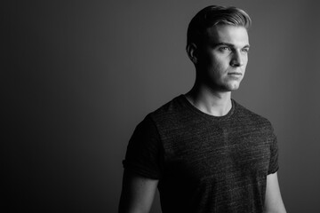 Face of young handsome man in black and white