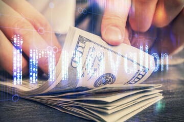 Double exposure of technology drawing hologram and us dollars bills and man hands. Data concept