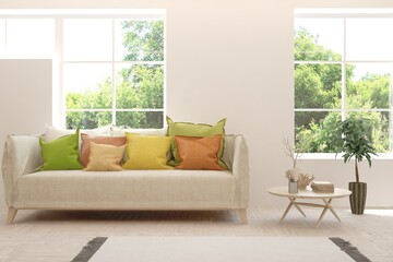 Fototapeta premium White living room with sofa and summer landscape in window. Scandinavian interior design. 3D illustration