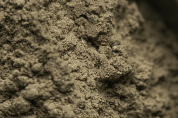 Green cosmetic clay or face powder textured background, close up