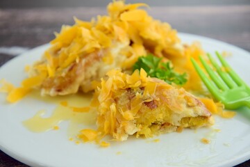 Pisang Goreng or fried banana with grated cheese and condensed milk