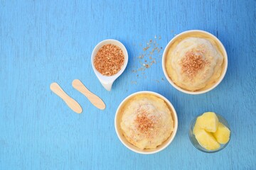 Coconut pineapple yogurt ice cream on blue background