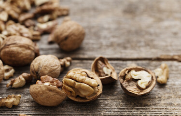 Fototapeta na wymiar walnuts on old wooden background