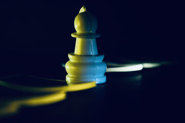plastic chess pieces on dark surface 