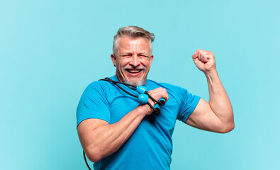 senior handsome man practising fitness and wearing sport clothes