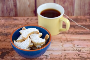 Putri Salju or crescent-shaped cookies coated with powdered sugar. Traditional Indonesian cookies to celebrate Eid al Fitr