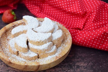 Putri Salju or crescent-shaped cookies coated with powdered sugar. Traditional Indonesian cookies to celebrate Eid al Fitr