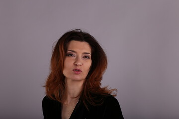 Obraz premium Studio portrait of elegant woman in black jacket