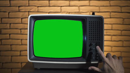 Photo of turning on the retro tv with green screen