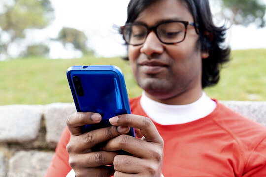 young man writing concentrated on the mobile