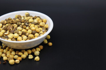 roasted chana with sweet kheel or chikpeas Bengal Grams also known as chatpata futana or Phutana flavored with spicy Indian Masala mithi sheel