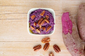 Mashed purple sweet potato with pecan nuts and maple syrup