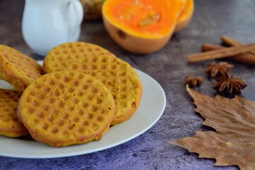 Homemade pumpkin cinnamon waffle pancakes with butter and maple syrup