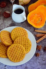 Homemade pumpkin cinnamon waffle pancakes with butter and maple syrup