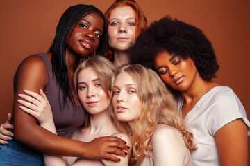 Obraz premium young pretty caucasian, afro, scandinavian woman posing cheerful together on brown background, lifestyle diverse nationality people concept