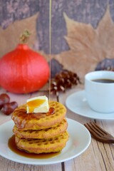 Homemade pumpkin cinnamon waffle pancakes with butter and maple syrup