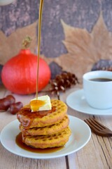 Homemade pumpkin cinnamon waffle pancakes with butter and maple syrup