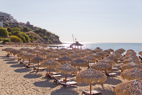 Straw umbrellas on the beach in Sveti Vlas, Bulgaria during sunny day.