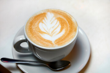 A cup of coffee. Latte with a pattern in a white cup.