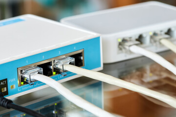 Ethernet cables connected to Desktop Switch and routerboard. Close-up, selective focus