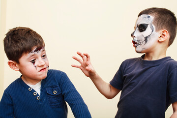 zombie apocalypse kids concept. Birthday party celebration facepaint on children scar face,...