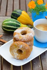 Cinnamon pumpkin donuts with a cup of coffee