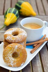 Pumpkin donuts with a cup of coffee